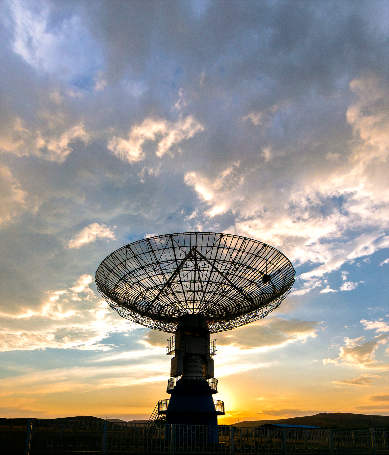 Photo of a satellite pointing up toward the sky