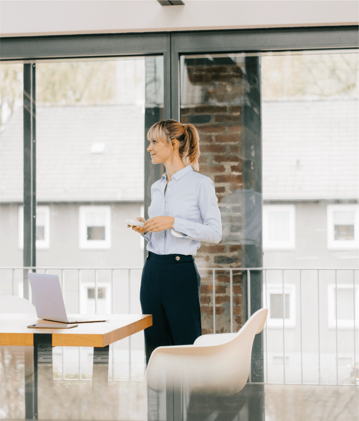 Businesswoman standing in a conference room holding a phone